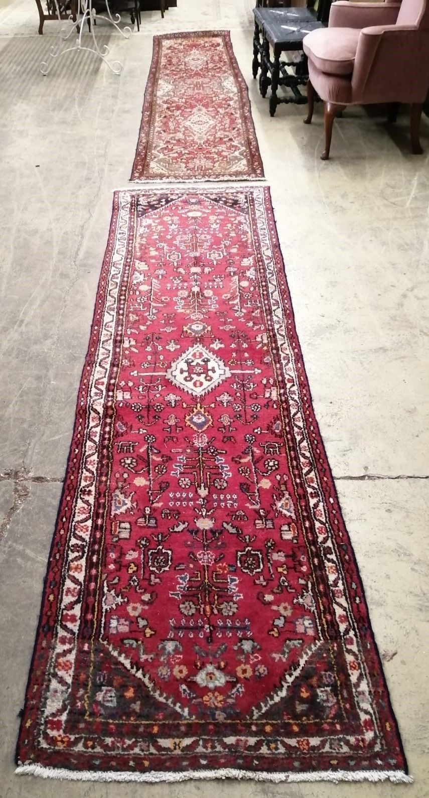 Two Caucasian red ground runners, larger 312 x 71cm